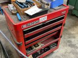 a red tool cart with tools on it in a garage