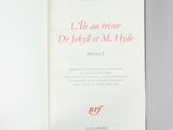 an open book with red writing on it sitting on a table