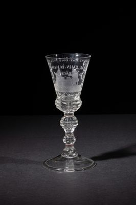 a wine glass that is sitting on a table