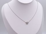 a close up of a necklace on a mannequin with a white background