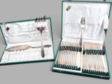 two open cases with forks and spoons in them