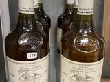 three bottles of chateau chambo are sitting on a glass shelf