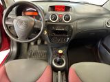 a dashboard of a small car with a steering wheel