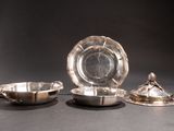 a silver plate with a silver bowl and a silver plate with a silver lid