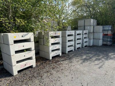a lot of boxes stacked on top of each other in a parking lot