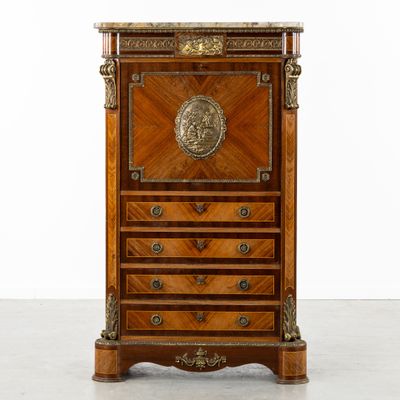une commode ancienne ornée d'un médaillon sur le dessus
