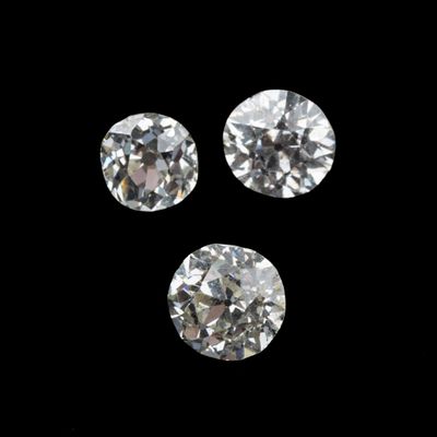 three round cut diamonds on a black background