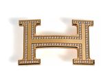 a gold and diamond letter h brooch