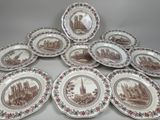 six assiettes marron et blanches ornées d'une illustration représentant un château