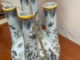 three vases that are sitting on a wooden table
