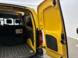 a yellow van with its doors open in a garage