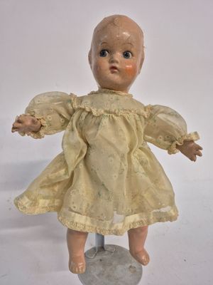 a small doll that is sitting on top of a rock