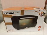 packaging of a black toaster oven sitting on top of a white table