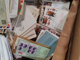 a box full of letters and envelopes on the floor