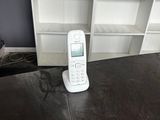 a cell phone sitting on a table in front of a bookshelf