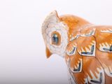 a figurine of an owl made of clay