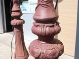 a red lamp post sitting on the side of the street