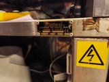 a sign on the door of a machine that has a warning sticker on it