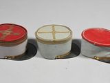 three hats sitting next to each other on a white surface