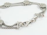 a close up of a silver chain bracelet with a clasp