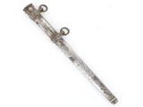 an old silver dagger with a metal handle on a white surface