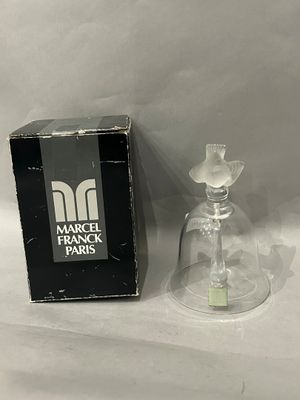 a small glass vase with a flower inside of it