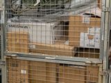 a large metal cage with a bunch of boxes in it