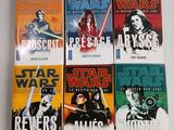 five star wars books are lined up on a white surface