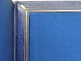 a close up of a blue book with a gold border