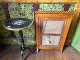 a small table and a cabinet in the corner of a room