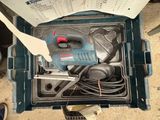 an overhead view of a tool box with a corded drill and a corded hammer