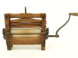 an old wooden machine with a roll of toilet paper in it