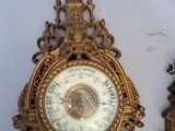 two clocks that are on the wall next to each other