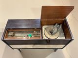 a wooden box with a metal object inside of it