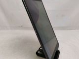 a close up of a tablet computer on a stand on a white surface