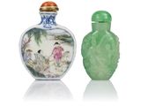 two green glass snuff bottles sitting next to each other on a white surface