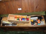 a wooden box filled with assorted items on top of a table