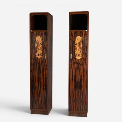 two tall wooden boxes with carvings on them on a white surface