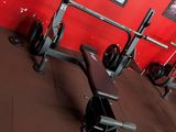 a gym room with a barbell rack in it