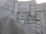 a button on the pocket of a pair of pants