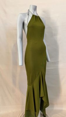 the dress is green and has a high neck and a ruffled skirt