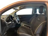 the interior of a small car with two leather seats and a steering wheel