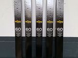 four skis are lined up against a wall in a row