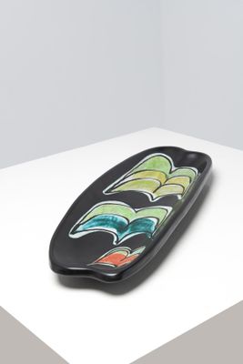 une image représentant une assiette noire ornée d'un motif coloré