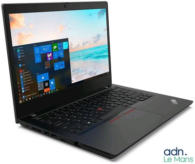 the laptop is open on a white surface with windows on the screen