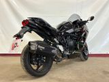 a picture of a black motorcycle parked in a garage