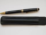 an image of a pen and a pen case sitting on a table