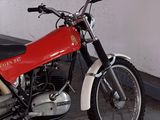 a red and white motorcycle parked in a garage