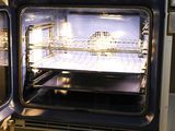 two ovens that are open in the kitchen