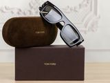 two pairs of sunglasses sitting on top of a box on top of a table